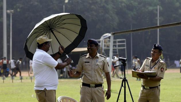 Police officials interact with each other during the police recruitment drive at Shivajinagar Police Headquaters in Pune. (RAHUL RAUT/ht photo )