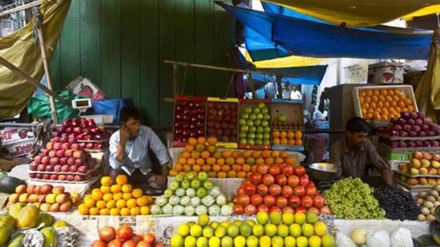 A fruit seller talks on his phone in a wholesale market in Guwahati. (AP File Photo) A fruit seller talks on his phone in a wholesale market in Guwahati. (AP File Photo)
