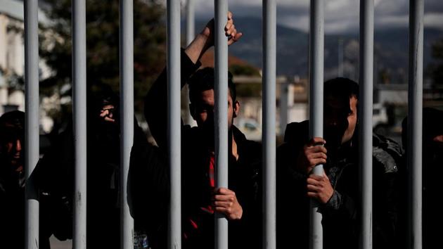 Migrants stand behind a metal fence at the port of Patras, from where they attempt the crossings. “Everything is dangerous,” said Arshad Wardak, 24, from Afghanistan. “You have to go through all the suffering to get into a better place. So this is why everybody is trying.” (Alkis Konstantinidis / REUTERS) Migrants stand behind a metal fence at the port of Patras, from where they attempt the crossings. “Everything is dangerous,” said Arshad Wardak, 24, from Afghanistan. “You have to go through all the suffering to get into a better place. So this is why everybody is trying.” (Alkis Konstantinidis / REUTERS)