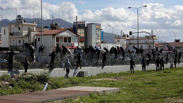 Dozens at a time can be seen bolting to scale a 2-km stretch of fence at the port, playing cat-and-mouse with police officers who push them back only for the men to try again hours later. They are part of a growing number of migrants in Greece trying daily to smuggle themselves onto ferries to get to Italy. (Alkis Konstantinidis / REUTERS) Dozens at a time can be seen bolting to scale a 2-km stretch of fence at the port, playing cat-and-mouse with police officers who push them back only for the men to try again hours later. They are part of a growing number of migrants in Greece trying daily to smuggle themselves onto ferries to get to Italy. (Alkis Konstantinidis / REUTERS)