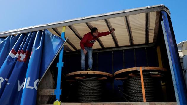 Anger simmers among truck drivers, who sometimes chase migrants away with sticks, fearing arrest if a stowaway is found in their freight. One driver, who gave his name as Harry, climbed into his truck to find three migrants hiding among stacks of aluminum last week. “It doesn’t get more awful than this and no one takes responsibility,” he said. (Alkis Konstantinidis / REUTERS) Anger simmers among truck drivers, who sometimes chase migrants away with sticks, fearing arrest if a stowaway is found in their freight. One driver, who gave his name as Harry, climbed into his truck to find three migrants hiding among stacks of aluminum last week. “It doesn’t get more awful than this and no one takes responsibility,” he said. (Alkis Konstantinidis / REUTERS)