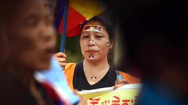 Tibetan people hold placards and flags during a peaceful protest against the Chinese government during commemorations of the 10th anniversary of the Tibetan Uprising, at Parliament Street near Jantar Mantar on Wednesday. (Raj K Raj / HT Photo) Tibetan people hold placards and flags during a peaceful protest against the Chinese government during commemorations of the 10th anniversary of the Tibetan Uprising, at Parliament Street near Jantar Mantar on Wednesday. (Raj K Raj / HT Photo)