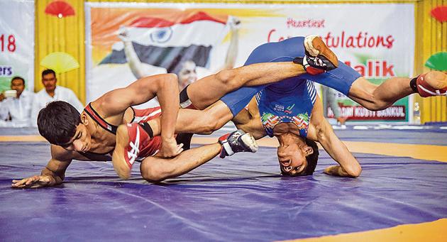 Solapur’s Saurabh Igave of Maharashtra (red) in action against Aman of Haryana on the last day of the 37th sub-junior national wrestling at Shiv Chhatrapati sports complex in Balewadi. (SANKET WANKHADE/HT PHOTO) Solapur’s Saurabh Igave of Maharashtra (red) in action against Aman of Haryana on the last day of the 37th sub-junior national wrestling at Shiv Chhatrapati sports complex in Balewadi. (SANKET WANKHADE/HT PHOTO)