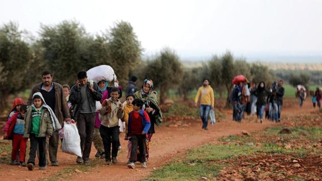 Internally displaced people walk with their belongings in the town of Inab, eastern Afrin, Syria on Wednesday. (Reuters Photo) Internally displaced people walk with their belongings in the town of Inab, eastern Afrin, Syria on Wednesday. (Reuters Photo)