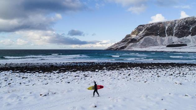 A surfer carries lugs board walking through snow out of the water in Unstad, Norway. Surrounded by breathtaking views of snow-covered mountaintops and cliffs dropping into the ocean, surfers and extreme sports enthusiasts looking for a unique experience come here from around the world; even in bone-chilling winters. (Oliver Morin / AFP) A surfer carries lugs board walking through snow out of the water in Unstad, Norway. Surrounded by breathtaking views of snow-covered mountaintops and cliffs dropping into the ocean, surfers and extreme sports enthusiasts looking for a unique experience come here from around the world; even in bone-chilling winters. (Oliver Morin / AFP)