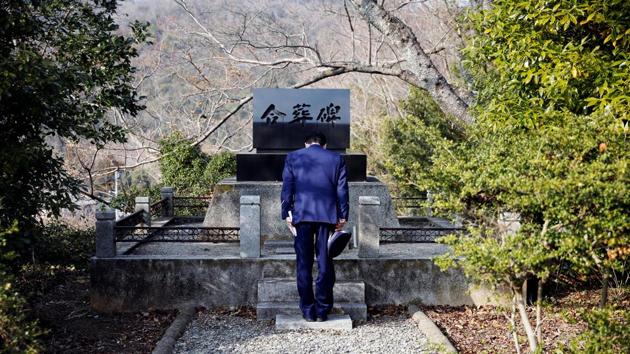 A prison officer bows to a grave for inmates. “I personally know people who willingly go back to prison,” said one ex-convict, who is staying at a halfway house in Tokyo after being released from prison in October. “As long as you are in prison, you get meals and a room.” (Toru Hanai / REUTERS) A prison officer bows to a grave for inmates. “I personally know people who willingly go back to prison,” said one ex-convict, who is staying at a halfway house in Tokyo after being released from prison in October. “As long as you are in prison, you get meals and a room.” (Toru Hanai / REUTERS)