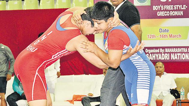 Maharashtra’s Srushti Bhosale (61kg) in action against Haryana’s Anshu (red) on day one of the 37th sun-junior nationals wrestling tourney held at Shiv Chhatrapati sports complex in Balewadi. (HT PHOTO) Maharashtra’s Srushti Bhosale (61kg) in action against Haryana’s Anshu (red) on day one of the 37th sun-junior nationals wrestling tourney held at Shiv Chhatrapati sports complex in Balewadi. (HT PHOTO)