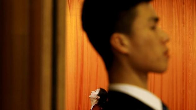 An attendant and a security officer are framesd at the entrance to the assembly hall during the fourth plenary session of the National People's Congress (NPC) at the Great Hall of the People in Beijing, China. (Thomas Peter / REUTERS) An attendant and a security officer are framesd at the entrance to the assembly hall during the fourth plenary session of the National People's Congress (NPC) at the Great Hall of the People in Beijing, China. (Thomas Peter / REUTERS)