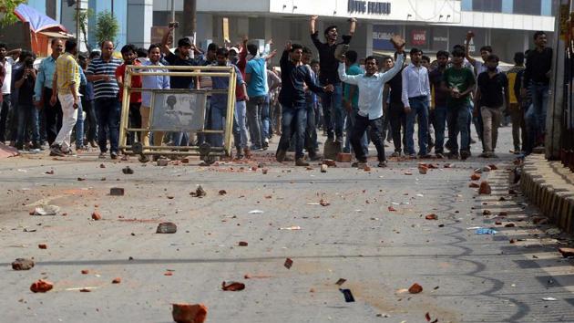 Bihar Police SI aspirants throw stones at security personnel during a protest over an alleged paper leak in Patna on Friday. (PTI) Bihar Police SI aspirants throw stones at security personnel during a protest over an alleged paper leak in Patna on Friday. (PTI)