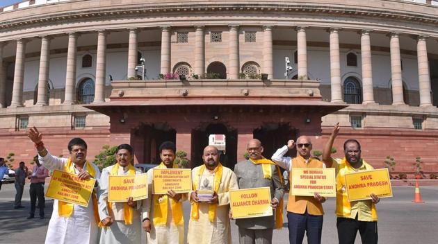 TDP leaders hold placards and raise slogans demanding special status for Andhra Pradesh during the Budget Session in Parliament on Tuesday.(PTI)