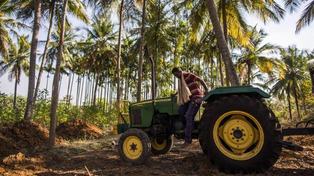 A farmer prepares to jump from a John Deere tractor, manufactured by Deere & Co., in the village of Kuragunda in Karnataka on March 8, 2018. (Prashanth Vishwanathan / Bloomberg) A farmer prepares to jump from a John Deere tractor, manufactured by Deere & Co., in the village of Kuragunda in Karnataka on March 8, 2018. (Prashanth Vishwanathan / Bloomberg)