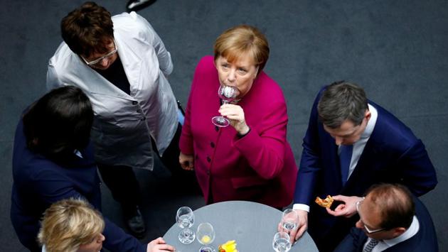 German Chancellor and leader of the Christian Democratic Union (CDU) Angela Merkel raises a toast after signing the coalition deal during a ceremony in Berlin, Germany. (Hannibal Hanschke / REUTERS) German Chancellor and leader of the Christian Democratic Union (CDU) Angela Merkel raises a toast after signing the coalition deal during a ceremony in Berlin, Germany. (Hannibal Hanschke / REUTERS)