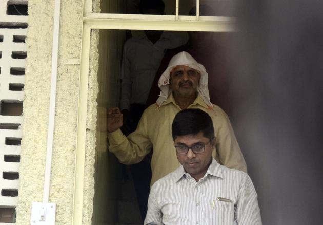 Milind Ekbote (In white scarf and cap) arrested from his residence at Shivajinagar by Pune Rural Police after his bail plea was rejected by court in the Koregaon Bhima violance case in Pune. (HT PHOTO) Milind Ekbote (In white scarf and cap) arrested from his residence at Shivajinagar by Pune Rural Police after his bail plea was rejected by court in the Koregaon Bhima violance case in Pune. (HT PHOTO)