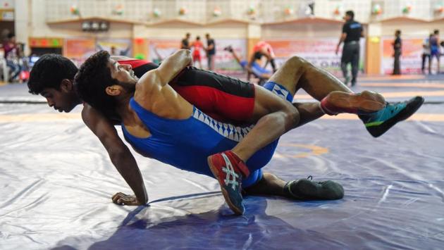 Contestants from different states fight it out on the mat at sub junior wrestling tournament held at Balewadi sports complex in Pune. (sanket wankhade/ht photo) Contestants from different states fight it out on the mat at sub junior wrestling tournament held at Balewadi sports complex in Pune. (sanket wankhade/ht photo)
