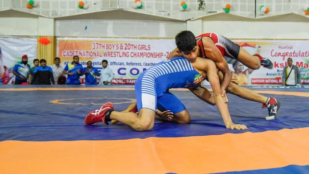 Solapur’s Saurabh Igave (red) is son of famous wrestler Madhukar Igave and is already under pressure to continue his father’s legacy. However during the sub-junior nationals the 17-year-old wrestler was worried about his SSC exams. (sanket wankhade/ht photo) Solapur’s Saurabh Igave (red) is son of famous wrestler Madhukar Igave and is already under pressure to continue his father’s legacy. However during the sub-junior nationals the 17-year-old wrestler was worried about his SSC exams. (sanket wankhade/ht photo)