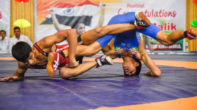 Solapur’s Saurabh Igave of Maharashtra (red) in action against Aman of Haryana on the last day of the 37th sub-junior national wrestling at Shiv Chhatrapati sports complex in Balewadi. (sanket wankhade/ht PHOTO) Solapur’s Saurabh Igave of Maharashtra (red) in action against Aman of Haryana on the last day of the 37th sub-junior national wrestling at Shiv Chhatrapati sports complex in Balewadi. (sanket wankhade/ht PHOTO)
