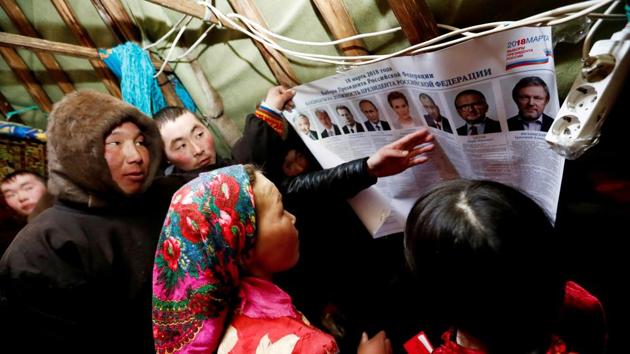 Yamb To community members scan a broadsheet with information about presidential candidates. “Who the president is has an impact on us, yes,” said a member of the community, Elena Tuleeva, 39. “If there are some laws there, they reach us too.” Tuleeva, who has always voted for Putin, said she knew several candidates in the race as she’d seen them on television. (Sergei Karpukhin / REUTERS) Yamb To community members scan a broadsheet with information about presidential candidates. “Who the president is has an impact on us, yes,” said a member of the community, Elena Tuleeva, 39. “If there are some laws there, they reach us too.” Tuleeva, who has always voted for Putin, said she knew several candidates in the race as she’d seen them on television. (Sergei Karpukhin / REUTERS)