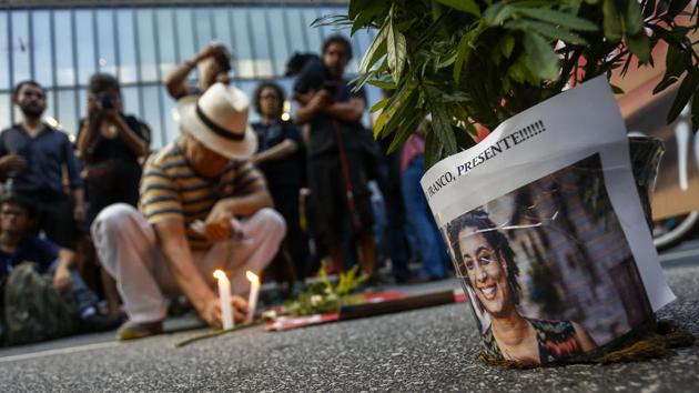 People take part in a rally against the murder of Brazilian councilwoman and activist Marielle Franco who was shot in the city center in an assassination-style killing. (Miguel Schincariol / AFP) People take part in a rally against the murder of Brazilian councilwoman and activist Marielle Franco who was shot in the city center in an assassination-style killing. (Miguel Schincariol / AFP)