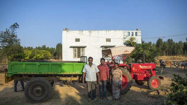 A farmer, left, stands with his family next to his newly purchased Mahindra 475 DI tractor, manufactured by Mahindra & Mahindra Ltd., outside his home in the village of Kuragunda in Karnataka, India, on Thursday, March 8, 2018. (Prashanth Vishwanathan / Bloomberg) A farmer, left, stands with his family next to his newly purchased Mahindra 475 DI tractor, manufactured by Mahindra & Mahindra Ltd., outside his home in the village of Kuragunda in Karnataka, India, on Thursday, March 8, 2018. (Prashanth Vishwanathan / Bloomberg)