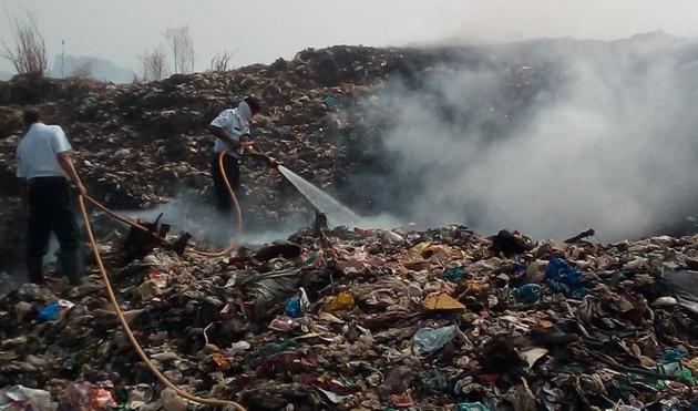 Two fire tenders are at the dumping ground, trying to douse the blaze. (Rishikesh Choudhary /HT Photo) Two fire tenders are at the dumping ground, trying to douse the blaze. (Rishikesh Choudhary /HT Photo)