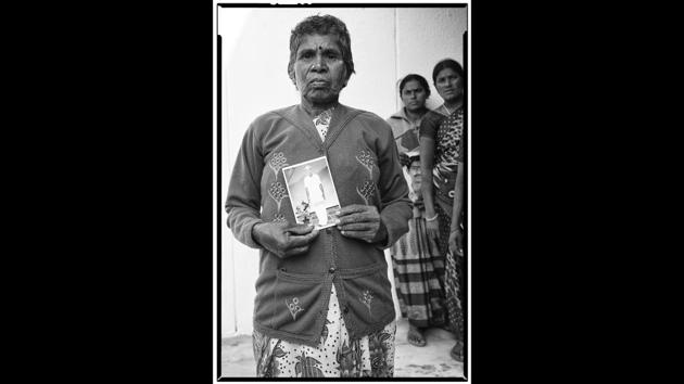 Ramanamma with a portrait of her deceased husband, A. Lakshmaiah, a tenant farmer from Mamillakunta Palli village. He committed suicide on July 25, 2015.  (Vijay Jodha) 