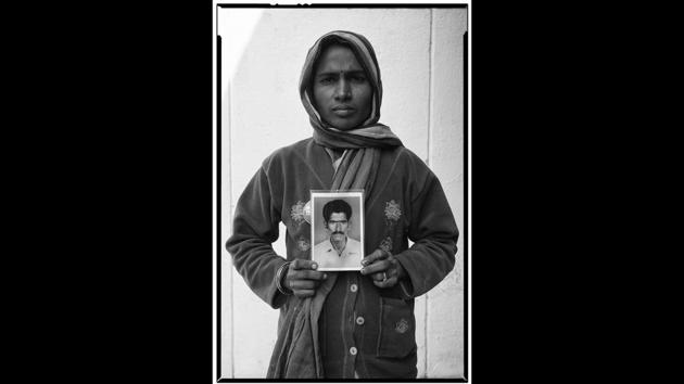 Yadamma with a portrait of her deceased husband Mallayya. There’s an uncanny similarity between the women and the people in the photographs they’re holding—their faces are grim in the wake of the agrarian crisis and its aftermath, the burden of life looming large before their eventual death. (Vijay Jodha) 