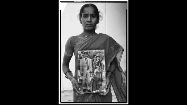 A widow with a portrait of her husband, herself and their child. Nearly 2,000 farmers committed suicide in Telangana between 2016-2017. (Vijay Jodha) 