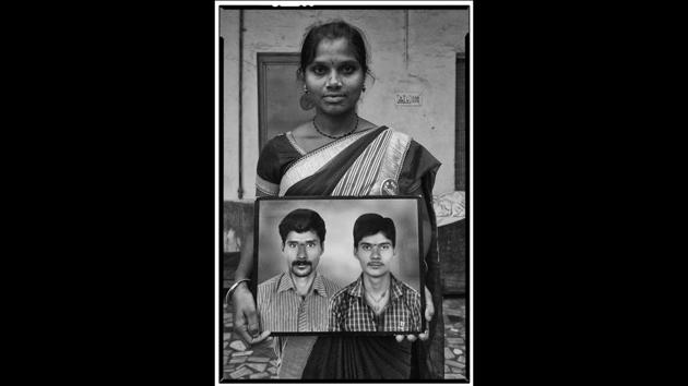 Devarajula Latha  with a framed photograph of her husband Devarajula Raju (left) and his younger brother, both of whom committed suicide in Telangana. (Vijay Jodha) 