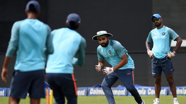 Indian cricket captain Rohit Sharma (2R) during fielding practice on the eve of the final. (AFP)