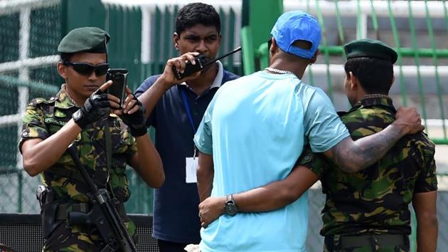 Security personnel click photos with Indian cricketers on the eve of the Nidahas Trophy final. (AFP)