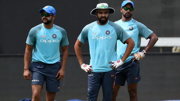 Rohit Sharma (C), Suresh Raina (L) and Shikhar Dhawan at the Premadasa Stadium in Colombo, looking at other teammates. (AFP)