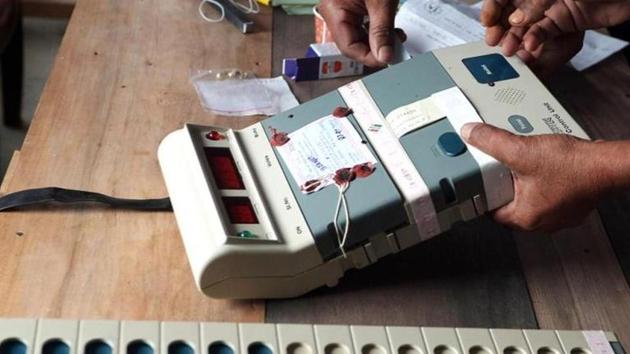 Election Commission officials seal an Electronic Voting Machine (EVM) prior to the start of voting at a polling station in Dibrugarh, Assam. The Congress said the Election Commission should revert to the old practice of paper ballot over EVMs.(AFP File Photo)