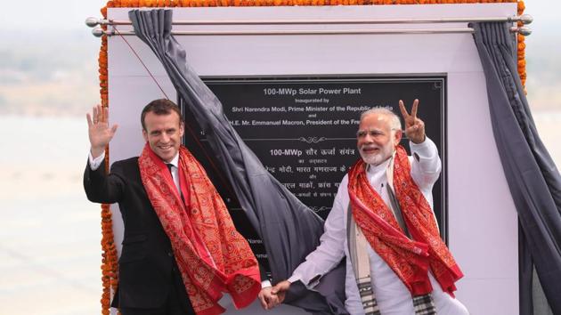 PM Narendra Modi (R) and French President Emmanuel Macron gesture at the opening of a solar power plant in Mirzapur on March 12. (Ludovic Marin / AFP) PM Narendra Modi (R) and French President Emmanuel Macron gesture at the opening of a solar power plant in Mirzapur on March 12. (Ludovic Marin / AFP)
