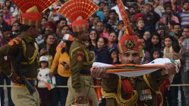An Indian Border Security Force soldier carries the national flag as he and others take part in the daily beating of the retreat ceremony at the India-Pakistan Wagah Border Post near Amritsar, on December 24, 2017. (AFP) An Indian Border Security Force soldier carries the national flag as he and others take part in the daily beating of the retreat ceremony at the India-Pakistan Wagah Border Post near Amritsar, on December 24, 2017. (AFP)