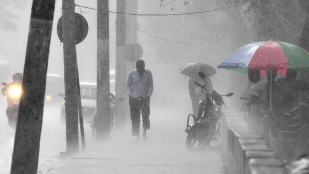 A man walks through heavy rain along a street in Guwahati on March 16. (Biju Boro / AFP) A man walks through heavy rain along a street in Guwahati on March 16. (Biju Boro / AFP)