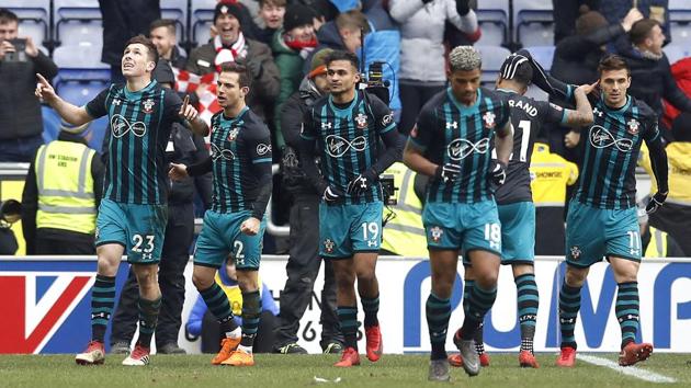 Southampton's Pierre-Emile Hojbjerg, left, celebrates scoring his side's first goal of the game against Wigan Athletic during the FA Cup quarterfinal at the DW Stadium in Wigan on Sunday. (AP) Southampton's Pierre-Emile Hojbjerg, left, celebrates scoring his side's first goal of the game against Wigan Athletic during the FA Cup quarterfinal at the DW Stadium in Wigan on Sunday. (AP)