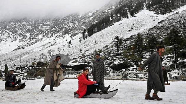 Tourists enjoy a sledge ride on a snow-covered hill after fresh snowfall at Sonamarg on March 15. (S. Irfan / PTI) Tourists enjoy a sledge ride on a snow-covered hill after fresh snowfall at Sonamarg on March 15. (S. Irfan / PTI)
