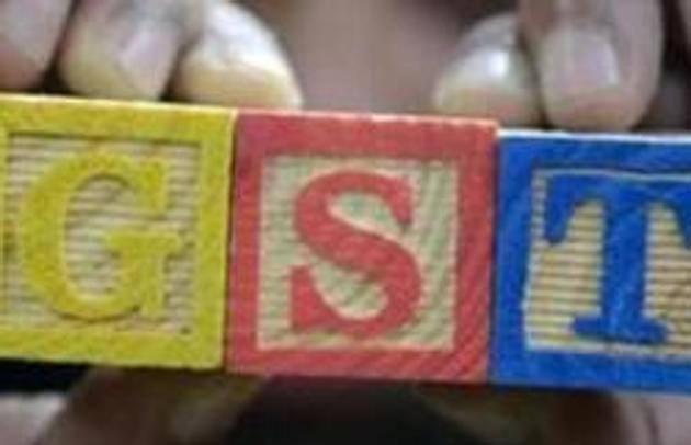 A trader shows letters GST representing "Goods and Services Tax" (GST) at his shop in Hyderabad on August 3, 2016. (AFP) A trader shows letters GST representing "Goods and Services Tax" (GST) at his shop in Hyderabad on August 3, 2016. (AFP)