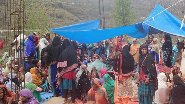 Villagers mourn the death of five members of a family killed in shelling by the Pakistani army along the LoC in Balakote sector of Poonch in Jammu on Sunday.(PTI Photo)