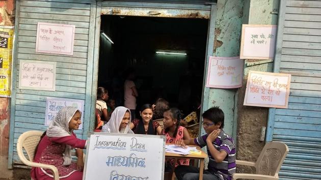 Residents of M-East ward at the ‘information centre’ set up in their slum to help fellow citizens. (APNALAYA) Residents of M-East ward at the ‘information centre’ set up in their slum to help fellow citizens. (APNALAYA)