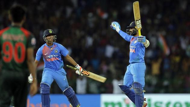 India's Dinesh Karthik (R) celebrates scoring the winning runs vs Bangladesh during the finals of Nidahas Trophy in Colombo, Sri Lanka on March 18, 2018.(AP)