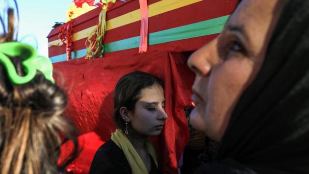 A woman mourns next to a coffin during the funeral of People’s Protection Units (YPG) fighters in Qamishli. The withdrawing Kurdish forces framed their exit as a move to prevent more civilian suffering. However, up against a foe with heavier firepower and a modern airforce, and with no foreign backer of their own, the Kurds faced a formidable battle to defend Afrin. The YPG forces have vowed to wage a guerrilla war against the Turkish military. (Delil Souleiman / AFP) A woman mourns next to a coffin during the funeral of People’s Protection Units (YPG) fighters in Qamishli. The withdrawing Kurdish forces framed their exit as a move to prevent more civilian suffering. However, up against a foe with heavier firepower and a modern airforce, and with no foreign backer of their own, the Kurds faced a formidable battle to defend Afrin. The YPG forces have vowed to wage a guerrilla war against the Turkish military. (Delil Souleiman / AFP)
