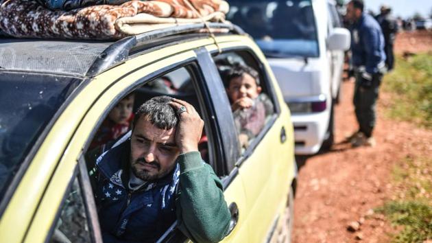 Syrian people arrive at a check point in the village of Anab ahead of crossing to the Turkish-backed Syrian rebels side. Turkish forces and their Syrian rebel allies swept into the northwestern Syrian town of Afrin, raising their flags in the town centre and declaring full control on Sunday after an eight-week campaign to drive out Kurdish YPG forces. More than 200,000 people have fled Afrin in recent days as reported by the Syrian Observatory. (Bulent Kilic / AFP) Syrian people arrive at a check point in the village of Anab ahead of crossing to the Turkish-backed Syrian rebels side. Turkish forces and their Syrian rebel allies swept into the northwestern Syrian town of Afrin, raising their flags in the town centre and declaring full control on Sunday after an eight-week campaign to drive out Kurdish YPG forces. More than 200,000 people have fled Afrin in recent days as reported by the Syrian Observatory. (Bulent Kilic / AFP)