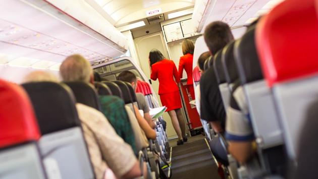 The survey concluded that on flights lasting three-and-a-half to five hours, passengers sitting one row in front, or one row behind, a person with flu, had an 80% risk of catching the bug.(Shutterstock)