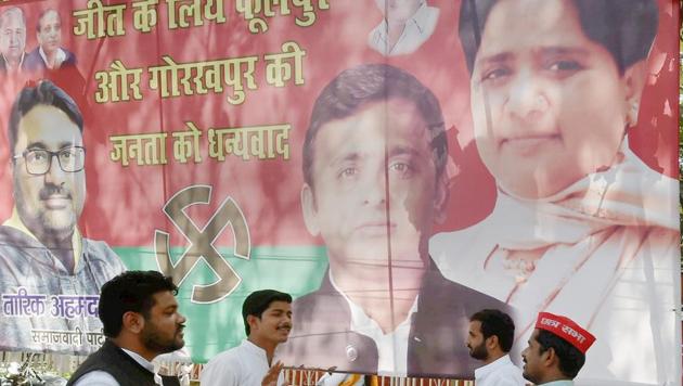 A poster featuring party chiefs Mayawati (BSP) and Akhilesh Yadav (SP) in Lucknow. The SP-BSP combine helped the parties beat the BJP in the Phulpur and Gorakhpur bypoll election in Uttar Pradesh.(PTI Photo)