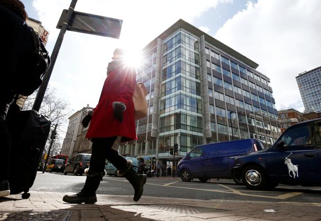 People walk past the building housing the offices of Cambridge Analytica in central London.(Reuters)