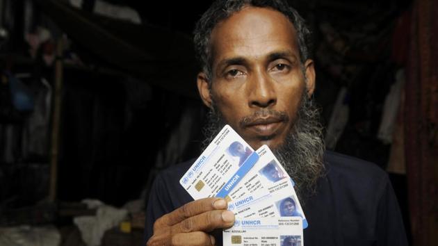A Rohingya refugee Azizullah, 45, shows UNHCR identity cards in Baruipur. “We were in a state of panic. However, locals gave us great support,” said Azizullah, a father of nine, who is now living with his wife and six children in a makeshift, thatched tent made of bamboo, polythene sheets and old saris. (Samir Jana / HT Photo) A Rohingya refugee Azizullah, 45, shows UNHCR identity cards in Baruipur. “We were in a state of panic. However, locals gave us great support,” said Azizullah, a father of nine, who is now living with his wife and six children in a makeshift, thatched tent made of bamboo, polythene sheets and old saris. (Samir Jana / HT Photo)