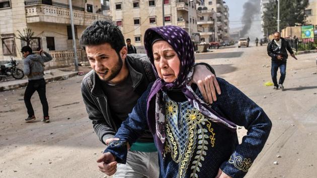 In Afrin, tens of thousands of civilians have fled as Turkish troops encircled the city but left a corridor open to the south. Men, women, and children crossed the front by foot along a dirt road, staggering under the weight of bags and suitcases, footage on state TV showed. Many carried infants on their shoulders or pushed them in strollers. Some elderly people hobbled on wooden sticks. (Bulent Kilic / AFP) In Afrin, tens of thousands of civilians have fled as Turkish troops encircled the city but left a corridor open to the south. Men, women, and children crossed the front by foot along a dirt road, staggering under the weight of bags and suitcases, footage on state TV showed. Many carried infants on their shoulders or pushed them in strollers. Some elderly people hobbled on wooden sticks. (Bulent Kilic / AFP)