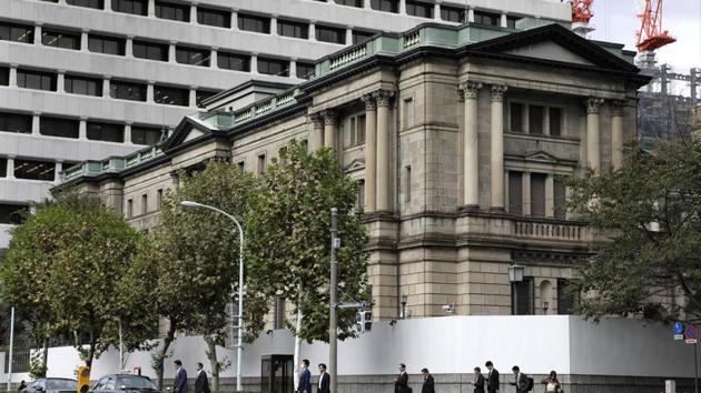 Pedestrians cross a road in front of the Bank of Japan (BOJ) headquarters in Tokyo, Japan. (Kiyoshi Ota/Bloomberg) Pedestrians cross a road in front of the Bank of Japan (BOJ) headquarters in Tokyo, Japan. (Kiyoshi Ota/Bloomberg)