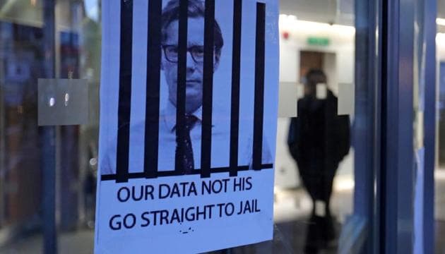 Posters depicting Cambridge Analytica's CEO Alexander Nix behind bars, with the slogan "Our Data Not His. Go Straight To Jail" are pictured at the entrance of the company's offices in central London .(AFP photo)